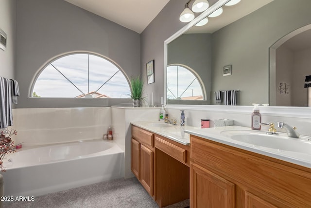 7460 E Kiowa Ave, Mesa, AZ 85209 - bathroom featuring double vanity, a bath, and vaulted ceiling