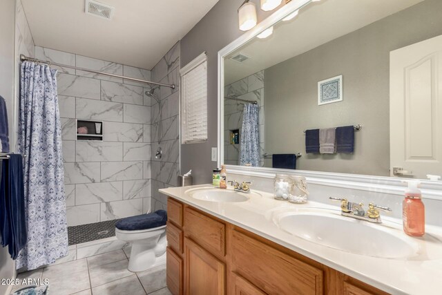 7460 E Kiowa Ave, Mesa, AZ 85209 - full bath featuring toilet, a tile shower, and double vanity