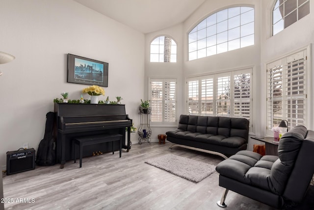 7460 E Kiowa Ave, Mesa, AZ 85209 - living area with wood finished floors, baseboards, and a high ceiling