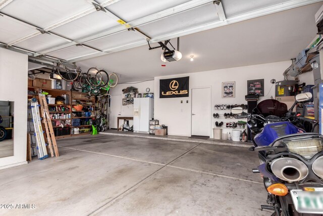 7460 E Kiowa Ave, Mesa, AZ 85209 - garage featuring a garage door opener and white refrigerator with ice dispenser