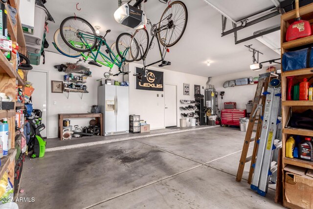 7460 E Kiowa Ave, Mesa, AZ 85209 - garage with white refrigerator with ice dispenser, gas water heater, a garage door opener, and a workshop area