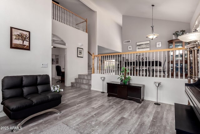 7460 E Kiowa Ave, Mesa, AZ 85209 - living area with stairway, high vaulted ceiling, and wood finished floors