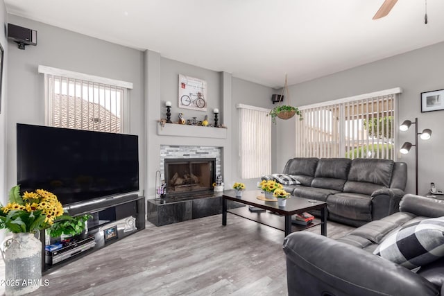 7460 E Kiowa Ave, Mesa, AZ 85209 - living room with healthy amount of natural light, ceiling fan, wood finished floors, and a fireplace
