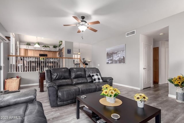 7460 E Kiowa Ave, Mesa, AZ 85209 - living area featuring ceiling fan, light wood-style floors, and baseboards
