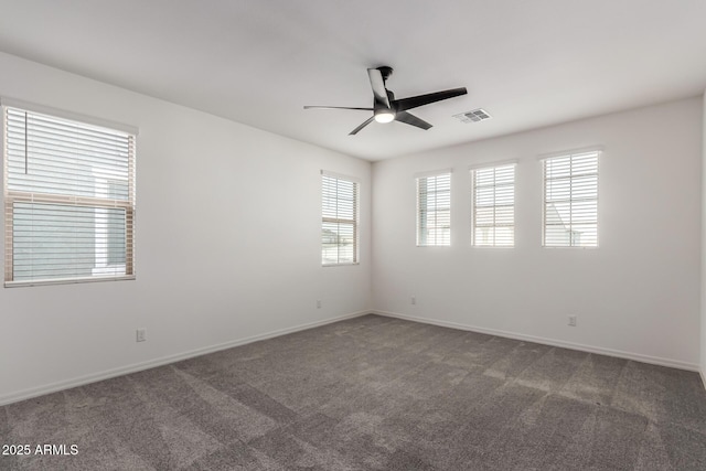 carpeted spare room featuring ceiling fan