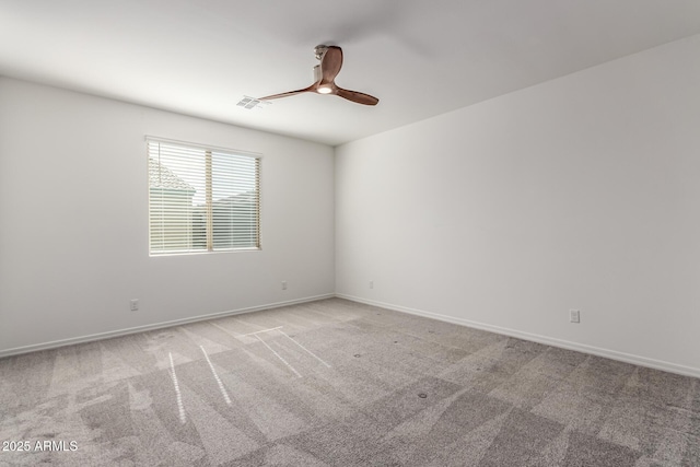 unfurnished room with light colored carpet and ceiling fan