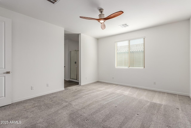 carpeted spare room featuring ceiling fan