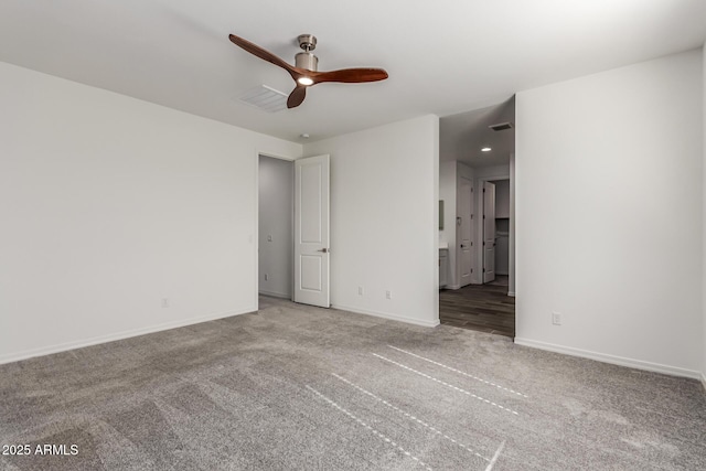 carpeted spare room featuring ceiling fan