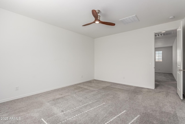 spare room featuring light carpet and ceiling fan