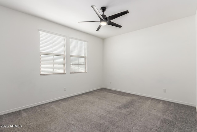 carpeted spare room featuring ceiling fan