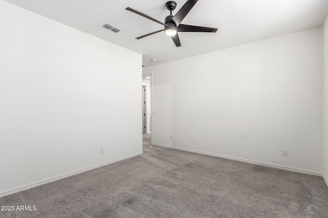 carpeted spare room featuring ceiling fan