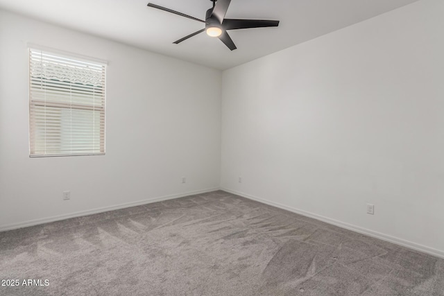 empty room with ceiling fan and light carpet