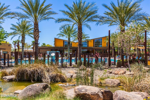 exterior space featuring a community pool and a water view