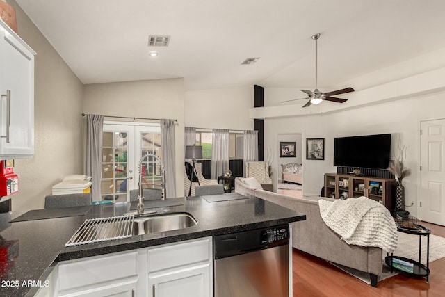 kitchen featuring dark countertops, visible vents, dishwasher, french doors, and a sink