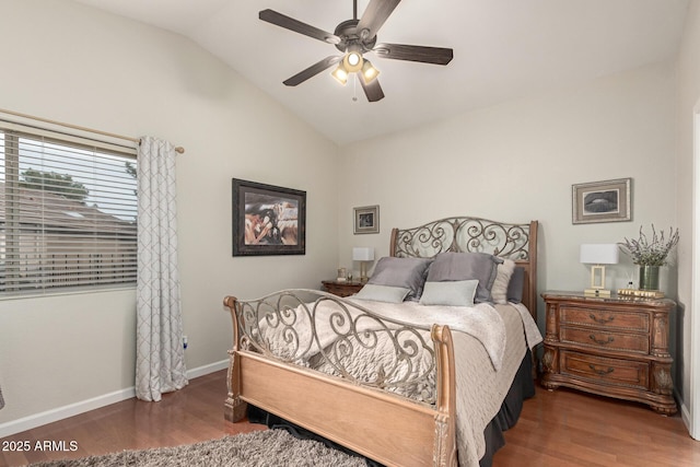 bedroom featuring wood finished floors, a ceiling fan, baseboards, and vaulted ceiling