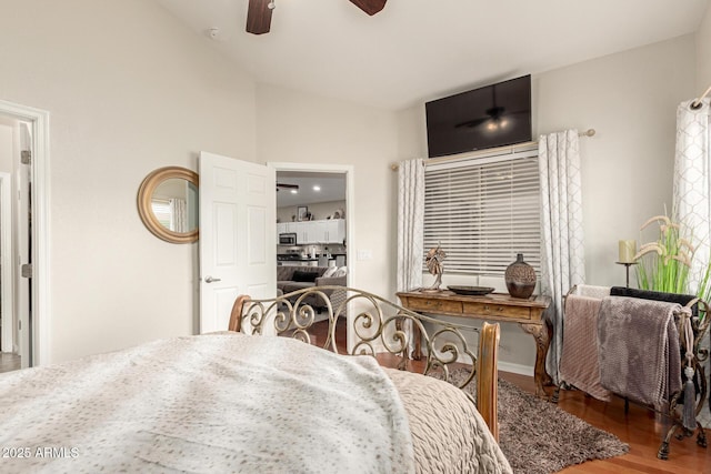 bedroom featuring ceiling fan, lofted ceiling, and wood finished floors