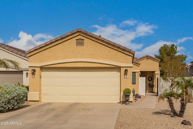 mediterranean / spanish-style house with a tiled roof, a garage, driveway, and stucco siding