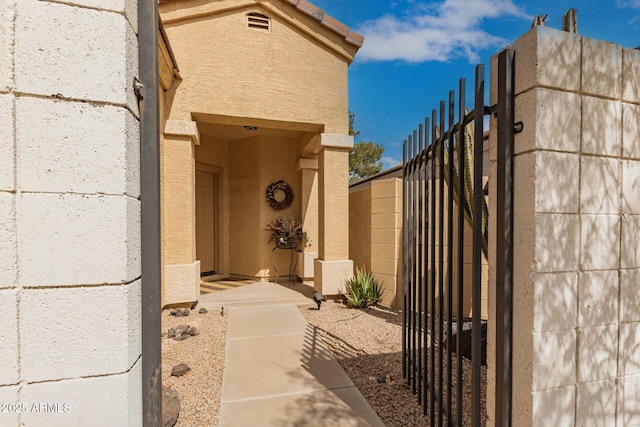 exterior space with stucco siding and fence