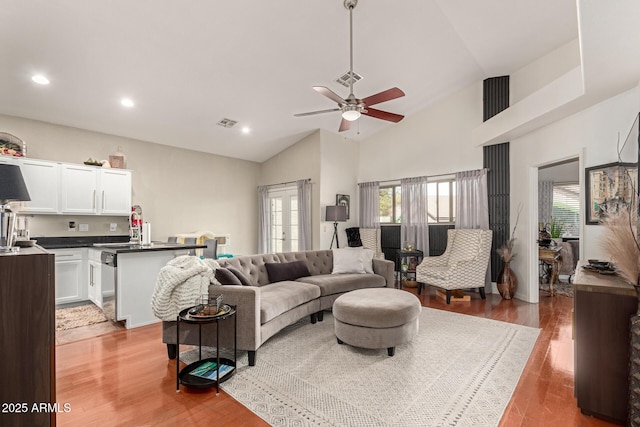 living area with visible vents, lofted ceiling, recessed lighting, ceiling fan, and light wood-type flooring