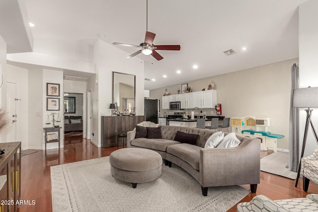 living area with visible vents, baseboards, ceiling fan, recessed lighting, and wood finished floors