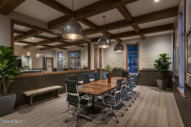 dining area with coffered ceiling, beam ceiling, and light hardwood / wood-style flooring