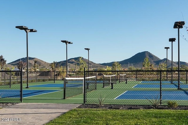 view of tennis court featuring a mountain view