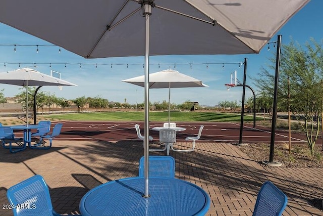 view of patio featuring basketball hoop