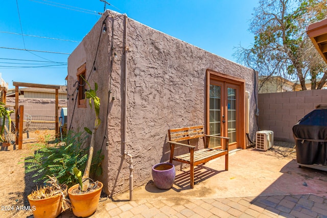 view of patio / terrace with ac unit and french doors