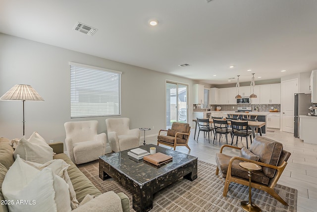 9352 E Saturn Ave, Mesa, AZ 85212 - living room featuring recessed lighting and baseboards