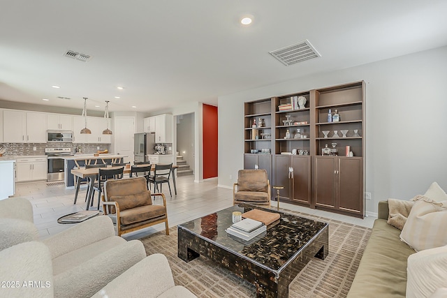 9352 E Saturn Ave, Mesa, AZ 85212 - living room with recessed lighting, light tile patterned floors, and baseboards