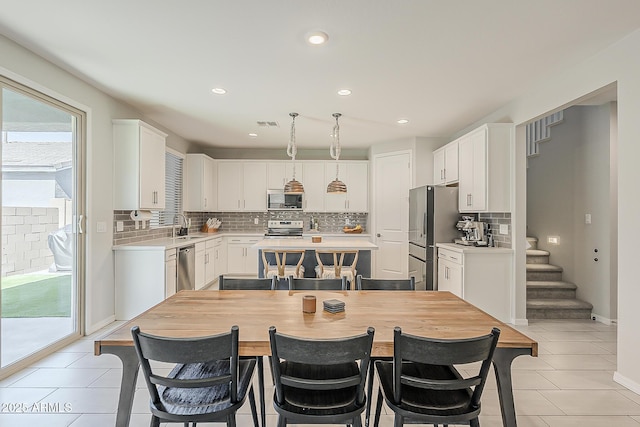 9352 E Saturn Ave, Mesa, AZ 85212 - dining space with light tile patterned flooring, recessed lighting, stairs, and baseboards