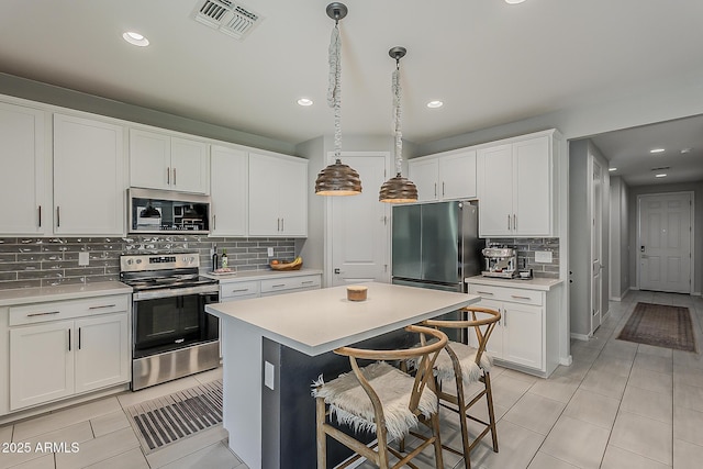 9352 E Saturn Ave, Mesa, AZ 85212 - kitchen with appliances with stainless steel finishes, light tile patterned flooring, backsplash, light countertops, and recessed lighting