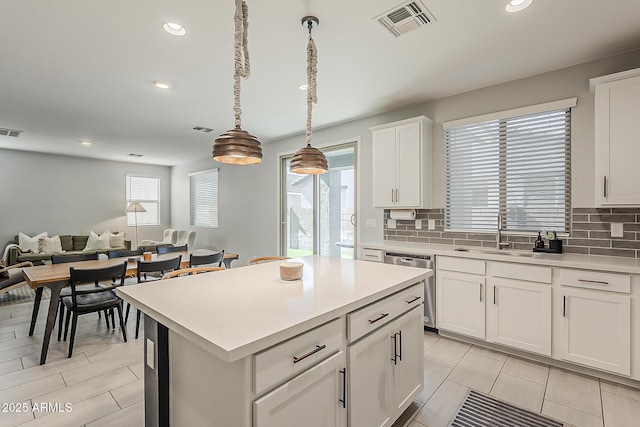 9352 E Saturn Ave, Mesa, AZ 85212 - kitchen featuring a sink, stainless steel dishwasher, tasteful backsplash, open floor plan, and recessed lighting