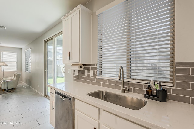 9352 E Saturn Ave, Mesa, AZ 85212 - kitchen featuring dishwasher, a sink, tasteful backsplash, and white cabinetry