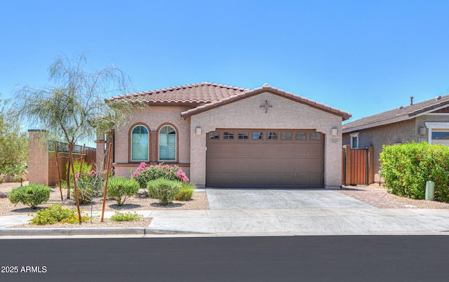 2929 E Mohave Ln, Apache Junction, AZ 85119 - mediterranean / spanish-style home with a tile roof, a garage, concrete driveway, and stucco siding