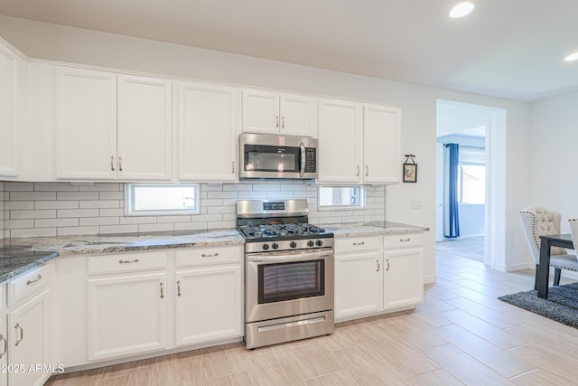 2929 E Mohave Ln, Apache Junction, AZ 85119 - kitchen with stainless steel appliances, decorative backsplash, white cabinets, light stone counters, and recessed lighting