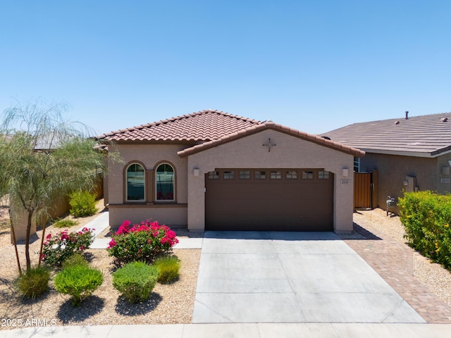 2929 E Mohave Ln, Apache Junction, AZ 85119 - mediterranean / spanish-style house with a tiled roof, a garage, concrete driveway, and stucco siding