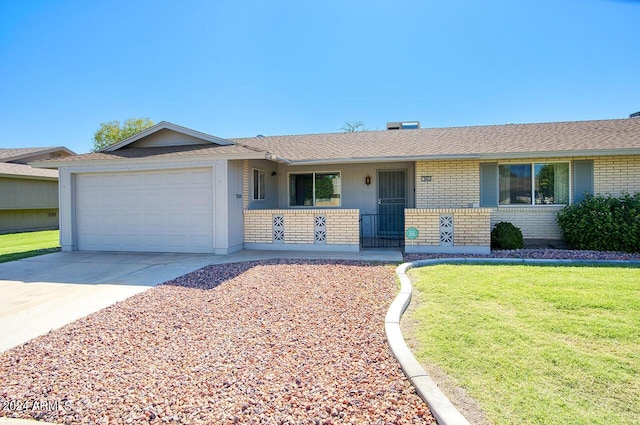 ranch-style home with covered porch, a garage, and a front lawn