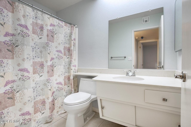 bathroom featuring toilet, vanity, tile patterned floors, and a shower with shower curtain