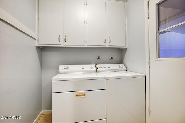 washroom with cabinets and independent washer and dryer