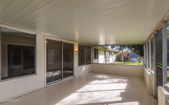 unfurnished sunroom with lofted ceiling