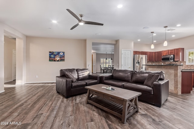 living room with ceiling fan and wood-type flooring