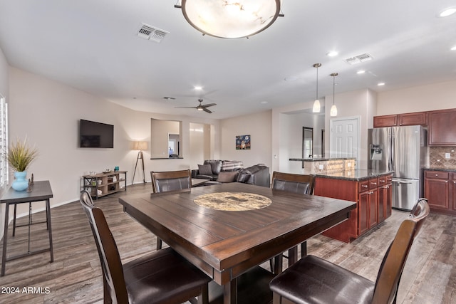 dining room with ceiling fan and dark hardwood / wood-style flooring