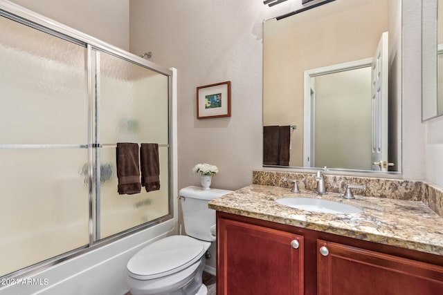 full bathroom with vanity, toilet, and enclosed tub / shower combo