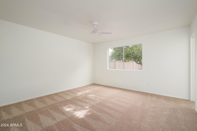 unfurnished room with light colored carpet and ceiling fan