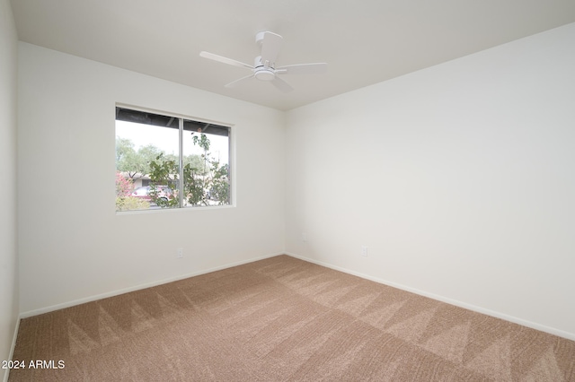 spare room featuring carpet flooring and ceiling fan