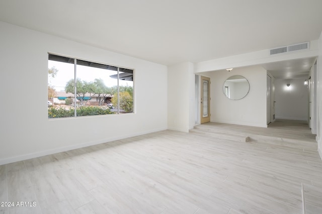 unfurnished room with light hardwood / wood-style flooring