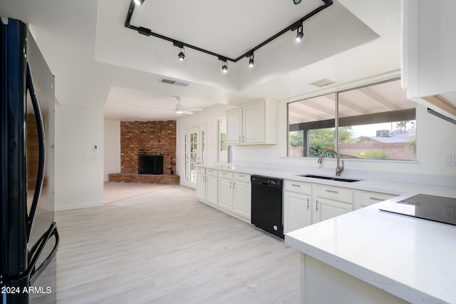 kitchen featuring white cabinetry, ceiling fan, sink, black appliances, and light wood-type flooring