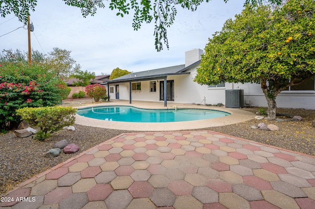 view of swimming pool featuring a patio and central AC unit