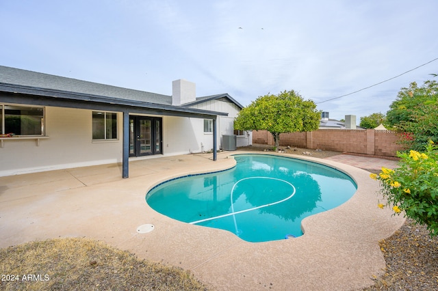 view of swimming pool featuring a patio and central AC